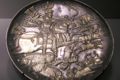 Photo of Sassanid Empire's Coins,Mosaics,Silver relief,Jewelry and seals,Pottery and stucco sculpture&Textiles. The Exhibition entitled Les Perses Sassanides, Fastes d'un Empire Oublié exhibits at the Cernuschi, Museum Paris.More than 200 items are presented at the exhibition and borrowed from the most prestigious international collections from museums in the United States, Europe and Iran testify of the diversity of this sumptuous art and of its various influences combining ancient Greek and authentic Persian traditions.The Kings court was equally sumptuous with grand parties given for princes and nobles of allied kingdoms. This ostentatious splendor encourages more "minor" arts. Silver dishes encrusted by gold coins featuring the King, Cups and Amphora's decorated by symbols related to Mazdean religion ( Pre-Islamic monotheistic religion) or shows dancers, musicians and jesters. Fine Crockery, rich silk, ceremonial jewel encrusted swords and gold or silver coins are displayed at the exhibition.
