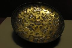 Photo of Sassanid Empire's Coins,Mosaics,Silver relief,Jewelry and seals,Pottery and stucco sculpture&Textiles. The Exhibition entitled Les Perses Sassanides, Fastes d'un Empire Oublié exhibits at the Cernuschi, Museum Paris.More than 200 items are presented at the exhibition and borrowed from the most prestigious international collections from museums in the United States, Europe and Iran testify of the diversity of this sumptuous art and of its various influences combining ancient Greek and authentic Persian traditions.The Kings court was equally sumptuous with grand parties given for princes and nobles of allied kingdoms. This ostentatious splendor encourages more "minor" arts. Silver dishes encrusted by gold coins featuring the King, Cups and Amphora's decorated by symbols related to Mazdean religion ( Pre-Islamic monotheistic religion) or shows dancers, musicians and jesters. Fine Crockery, rich silk, ceremonial jewel encrusted swords and gold or silver coins are displayed at the exhibition.